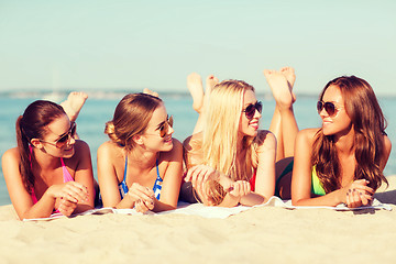 Image showing group of smiling women in sunglasses on beach