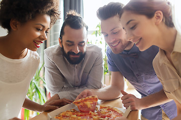 Image showing happy business team eating pizza in office