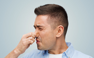 Image showing man wrying of unpleasant smell