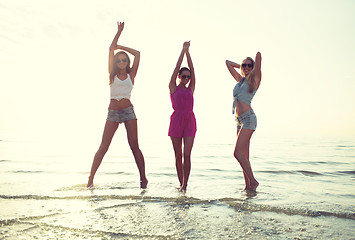 Image showing happy female friends dancing on beach