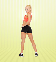 Image showing athletic woman in sportswear from back