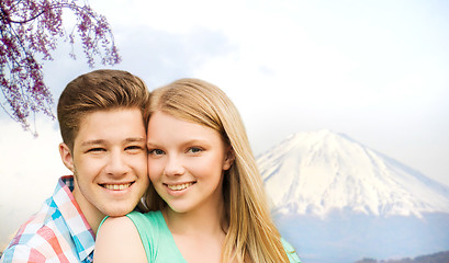 Image showing smiling couple hugging over fuji mountain in japan