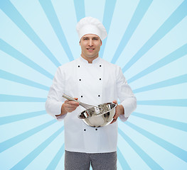 Image showing happy male chef cook whipping something with whisk