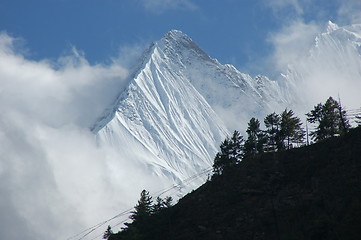 Image showing Himalayan peak behind hillside with prayerflags