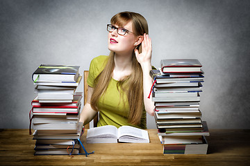 Image showing Listening female student with books