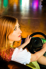 Image showing Beautiful girl in an electric bumper car in amusement park