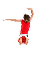 Image showing Boy jumping arms in grande pose.