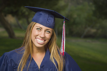Image showing Young Woman Wearing Cap and Gown Outdoors