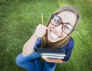 Image showing Wide Angle of Pretty Young Woman with Books and Pencil