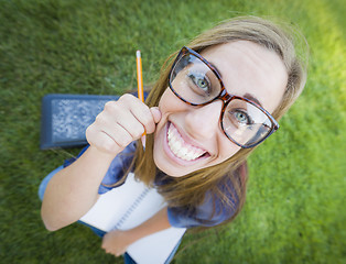 Image showing Wide Angle of Pretty Young Woman with Books and Pencil