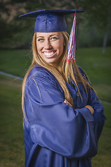 Image showing Young Woman Wearing Cap and Gown Outdoors