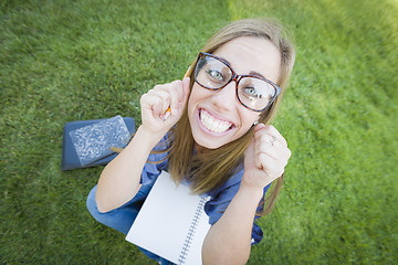 Image showing Wide Angle of Pretty Young Woman with Books and Pencil