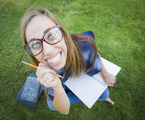 Image showing Wide Angle of Pretty Young Woman with Books and Pencil