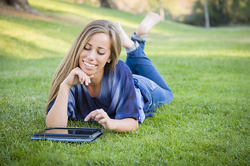 Image showing Smiling Young Woman Using Computer Tablet Outdoors