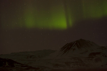 Image showing Northern lights with snowy mountains in the foreground