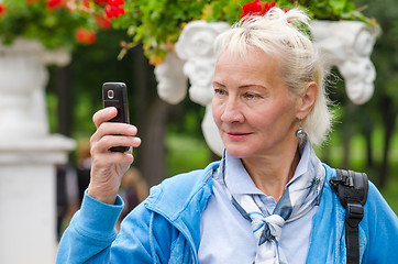 Image showing  woman photographed in a park on the phone  