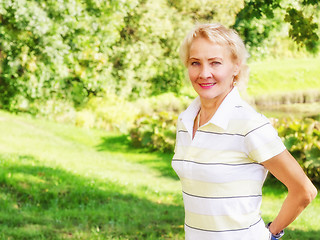 Image showing Portrait of a middle-aged woman in a park  