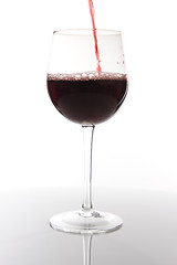 Image showing Red wine pouring down