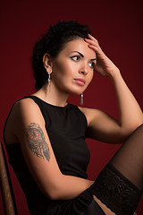 Image showing Studio portrait of a sexy brunette in black stockings