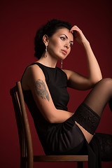 Image showing Studio portrait of a sexy brunette in black stockings