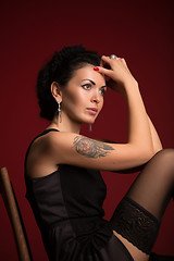 Image showing Studio portrait of a sexy brunette in black stockings