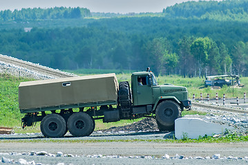 Image showing Curtain sided truck comes around on high obstacle