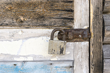 Image showing Rustic door locked with padlock