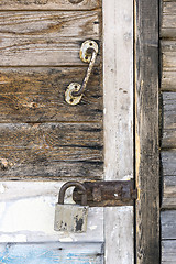 Image showing Wooden door locked with padlock