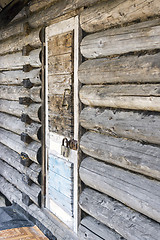 Image showing Old wooden door locked with padlock