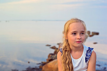 Image showing Portrait of little beautiful girl on sunset