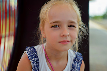 Image showing Little girl sitting on the bench