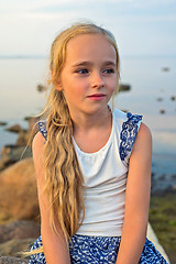 Image showing Portrait of little beautiful girl on sunset