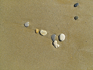Image showing Sand background with sea pebbles     