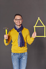 Image showing Man with hammer showing house frame concept