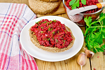 Image showing Sandwich with beet caviar on wooden board