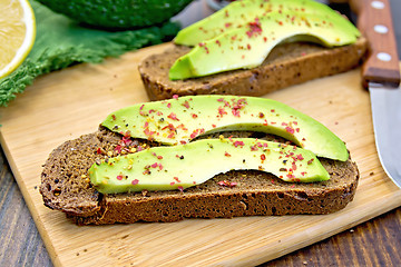 Image showing Sandwich with avocado and pepper on dark board