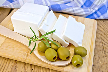 Image showing Feta with olives and rosemary in spoon on board