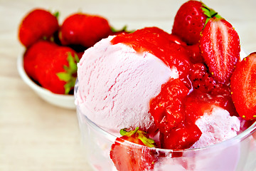 Image showing Ice cream strawberry in glass bowl on fabric