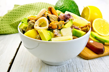 Image showing Salad seafood and avocado in bowl on light board