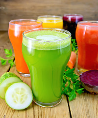 Image showing Juice cucumber and vegetable in glassful with parsley on board