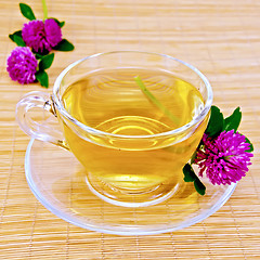 Image showing Herbal tea with clover on bamboo napkin