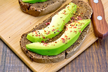 Image showing Sandwich with avocado and spices on board