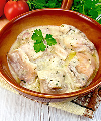 Image showing Fish stew in sauce on ceramic pan with tomatoes