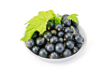Image showing Black currants in bowl with leaf