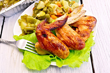 Image showing Chicken wings fried with vegetables and salad in plate