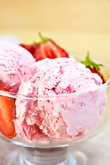 Image showing Ice cream strawberry in glass bowl on board