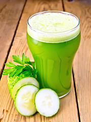 Image showing Juice cucumber in tall glassful on board