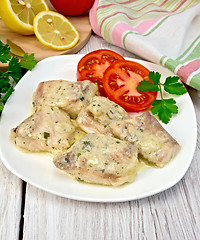 Image showing Fish stew in sauce on plate with lemon