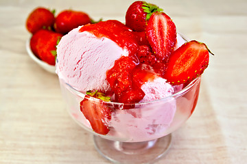 Image showing Ice cream strawberry in glass bowl with berries on fabric