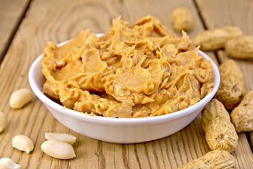 Image showing Butter peanut in bowl on board